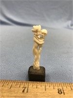Very tiny ivory carving of a man and a skeleton em