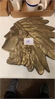 Brass Indianhead wall hanging may be connected to