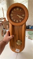 A oak wall clock pendulum type