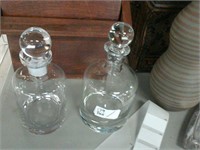 Pair of glass decanters with lids