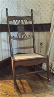 Wood rocking chair with woven seat