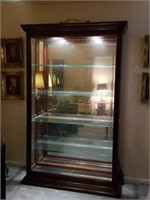 Beautiful lighted curio cabinet with glass shelves