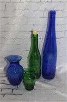 green and blue bottles and vases