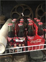 2 6pk coca cola bottles in their cardboard cases