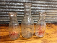 Three vintage milk bottles