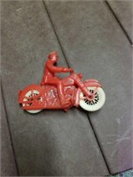 Red plastic man on motorcycle
