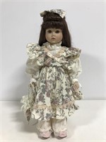 Porcelain little girl doll on stand
