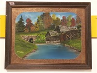 Framed painting of a home on the riverbank