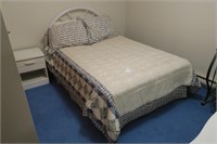 Full size bed with white metal frame headboard