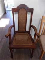 Wooden cane bottom chair with arms