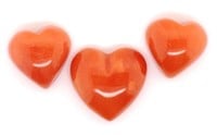 A set of three carved loose coral love hearts