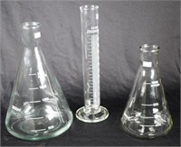 Three various glass measuring flasks