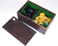 Box of carved timber chess pieces