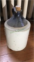 1/2 gallon stoneware jug with dark brown top,