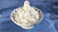 Milk glass hatching chick and stack of eggs