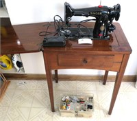 Singer electric sewing machine with walnut cabinet