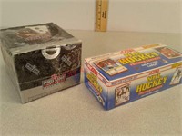 Two unopened boxes of hockey & football cards