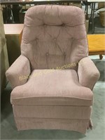 Small pink cushioned rocking chair