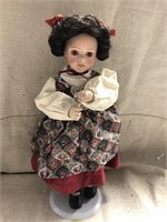 Dark haired porcelain musical doll