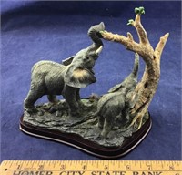 Statue of Elephant Pair Eating From Tree