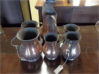 Six Copper Water Pitchers