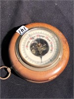 Barometer brass in a round wood case made in