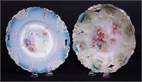 Two 10 1/2" floral cake plates, one marked