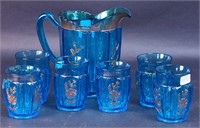 A 7" blue paneled water pitcher with gold