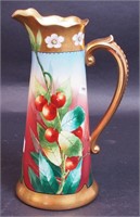 A hand-painted porcelain pitcher signed