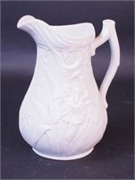 A Parian ware pitcher decorated