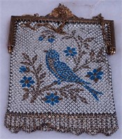 A mesh bag decorated with bluebirds,