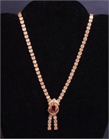 A gold-filled Victorian necklace with red stone