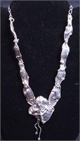 A unique handmade silver necklace, unmarked but