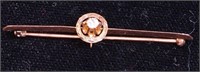 A 14K gold bar pin with diamond, tested