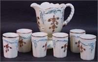 An ivory custard 8" water pitcher with gold