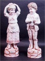 Two 17" high porcelain figurines of a boy and