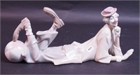 A Lladro figurine of a clown reclining with a