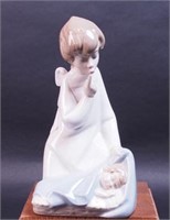 Lladro figurine of angel over sleeping baby,