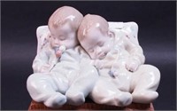 Lladro figurine of two babies sleeping against