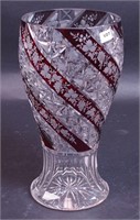 A cut glass vase with ruby flashing and