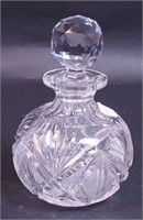 A 7" high cut glass bulbous cologne bottle