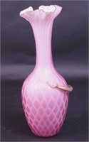 An 11" pink satin cased vase with applied