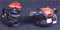 Two black Royal Bayreuth creamers: a cow's head