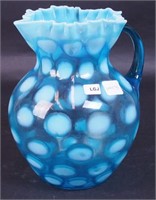 An 8 1/2" blue opalescent Coin Spot pitcher
