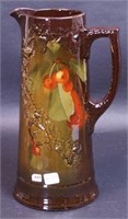 A brown Weller-style pitcher decorated