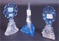 Three cut glass perfume bottles: one with blue