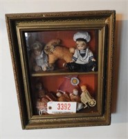 Antique wooden shadowbox frame with small dolls