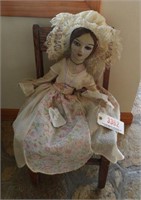 Antique doll in child’s Oak side chair