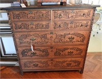 Seven drawer highly carved chest of drawers