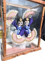 Asian dolls in a wooden and glass case, the case